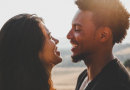 Smiling couple with sea behind